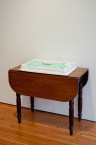 Divya Mehra, There's just not enough to go around, 2011. White cake with fruit, custard filling and whipped topping, mahogany British parlour table circa 1890, dimensions variable